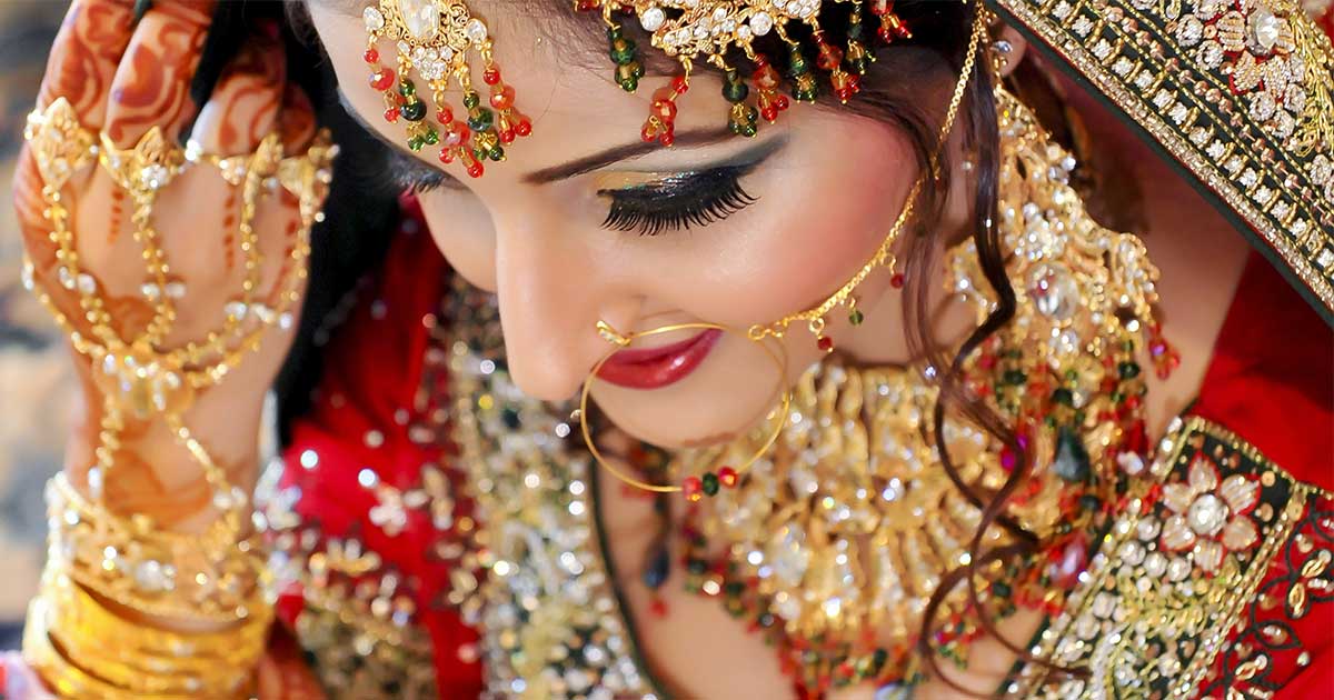 Close-up of an Indian bride's radiant face, adorned with traditional jewelry, capturing a blend of cultural beauty and personal joy.